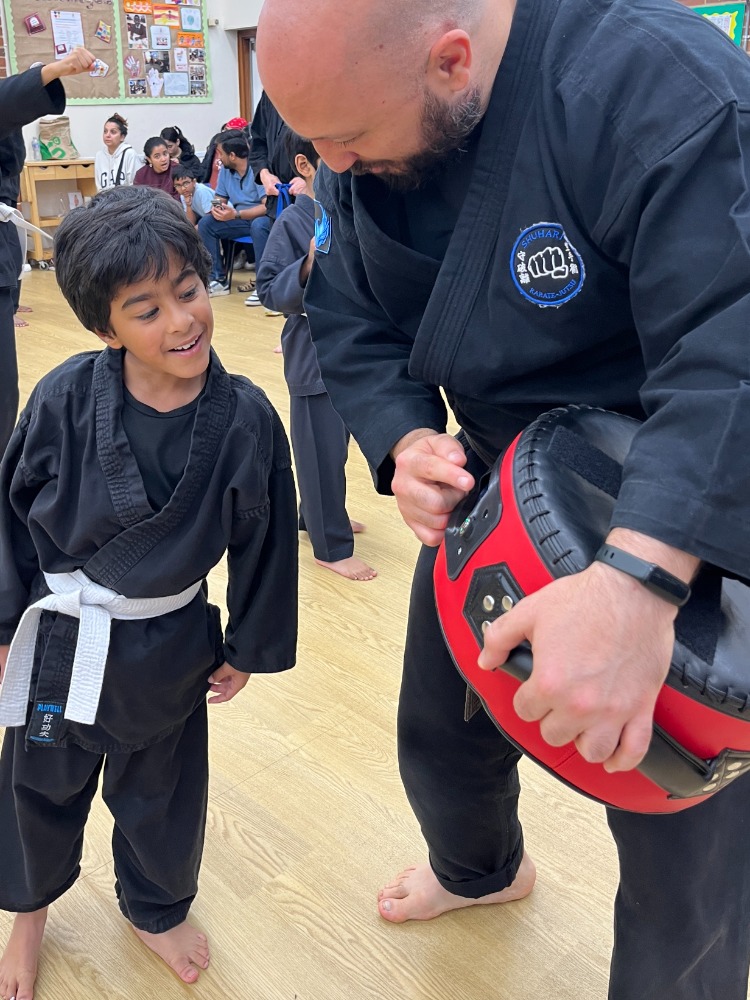 Active kids learning self-defence techniques in martial arts class as alternative to video games