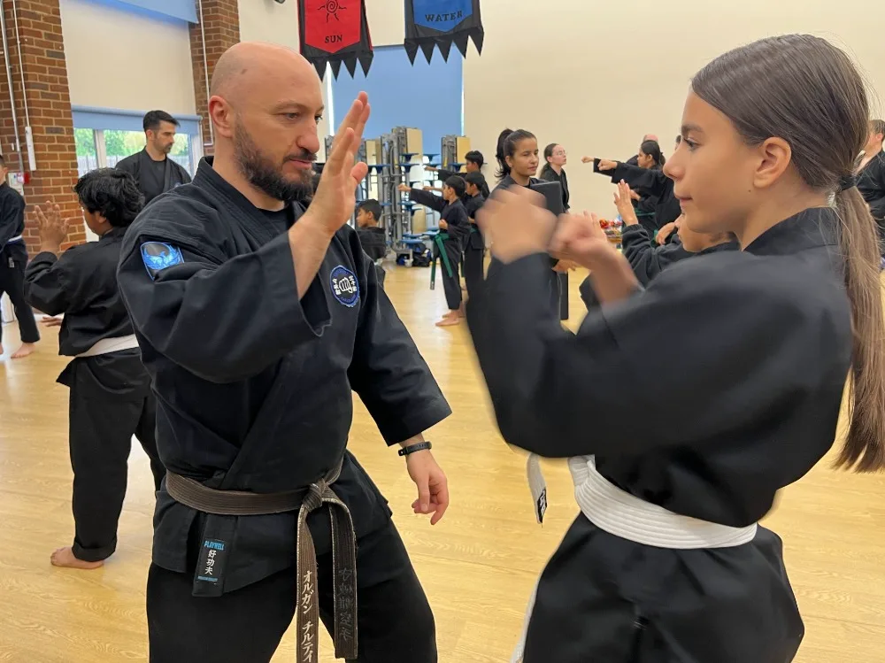 Shuhari Self Defence instructor assessing student technique during grading in Bracknell
