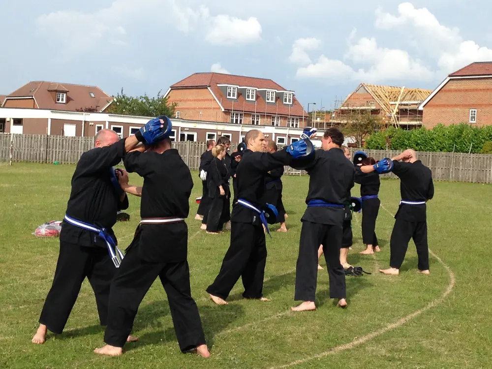 Students practicing martial arts techniques outdoors at Shuhari Self Defence training session in Maidenhead