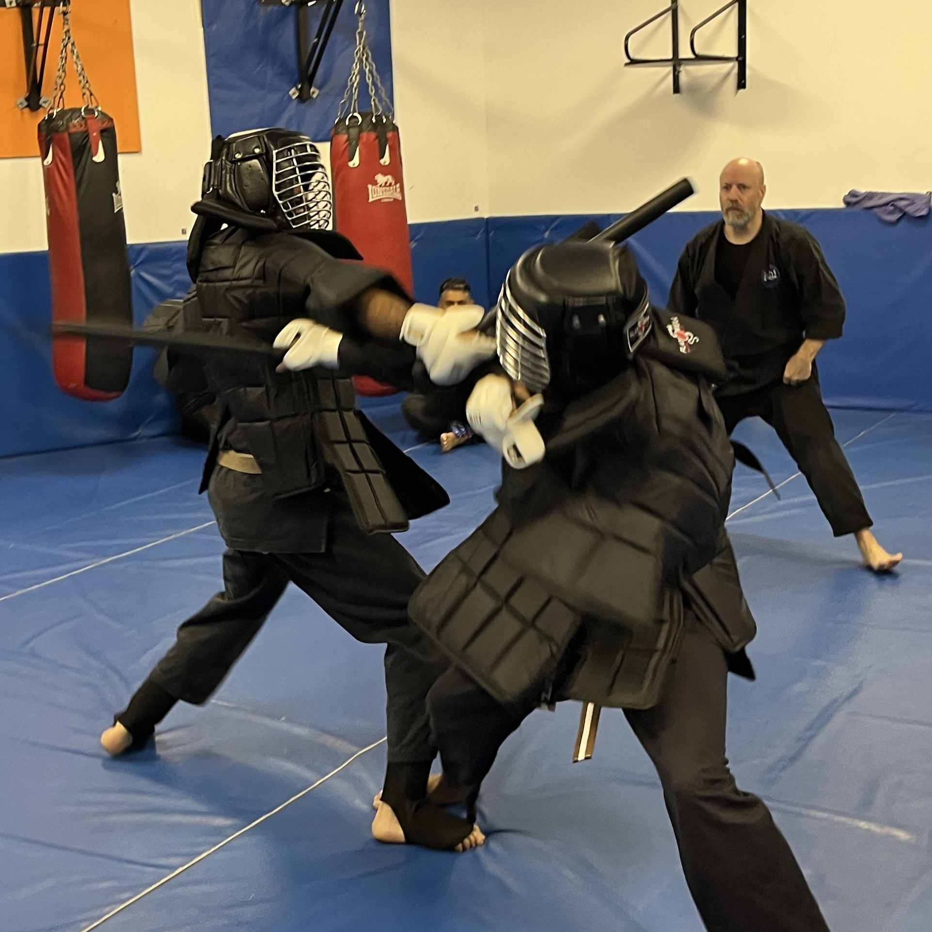 Brian Southon of Shuhari Self Defence Cippenham overseeing a weapons sparring bout in an adults martial arts class in Slough