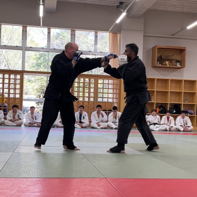 Brian Southon of Shuhari Self Defence Cippenham demonstrating karate sparring in a Judo class in Kogakkan school Japan