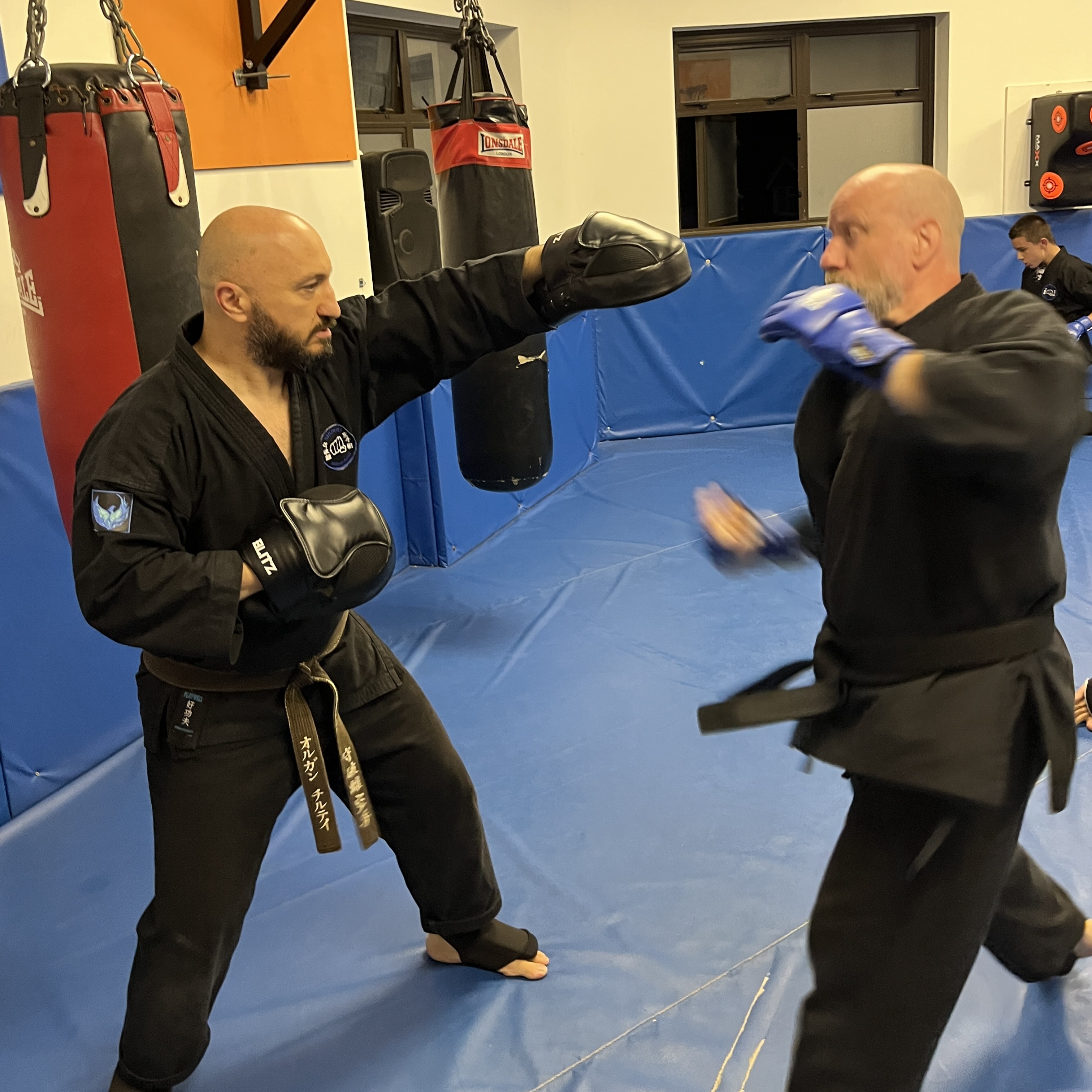 Brian Southon of Shuhari Self Defence Cippenham practicing pad work with his instructor Olgun Tiltay