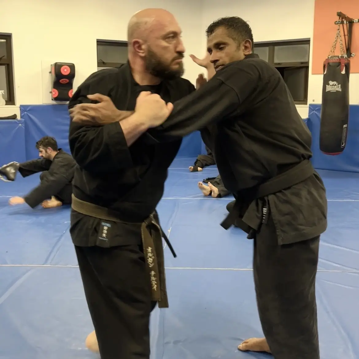 John Moses of Shuhari Self Defence Bracknell learning vertical grappling concepts from Olgun Tiltay in a martial arts class John Moses of Shuhari Self Defence Bracknell learning vertical grappling concepts from Olgun Tiltay in a martial arts class