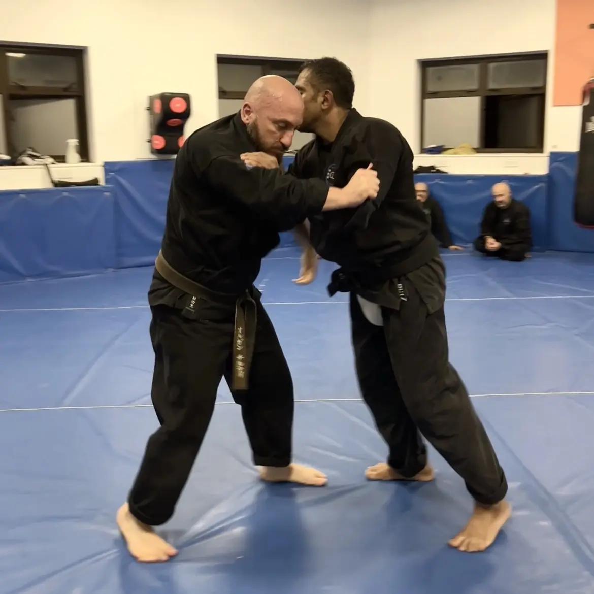 John Moses of Shuhari Self Defence Bracknell learning vertical grappling techniques from Olgun Tiltay in a martial arts class John Moses of Shuhari Self Defence Bracknell learning vertical grappling techniques from Olgun Tiltay in a martial arts class