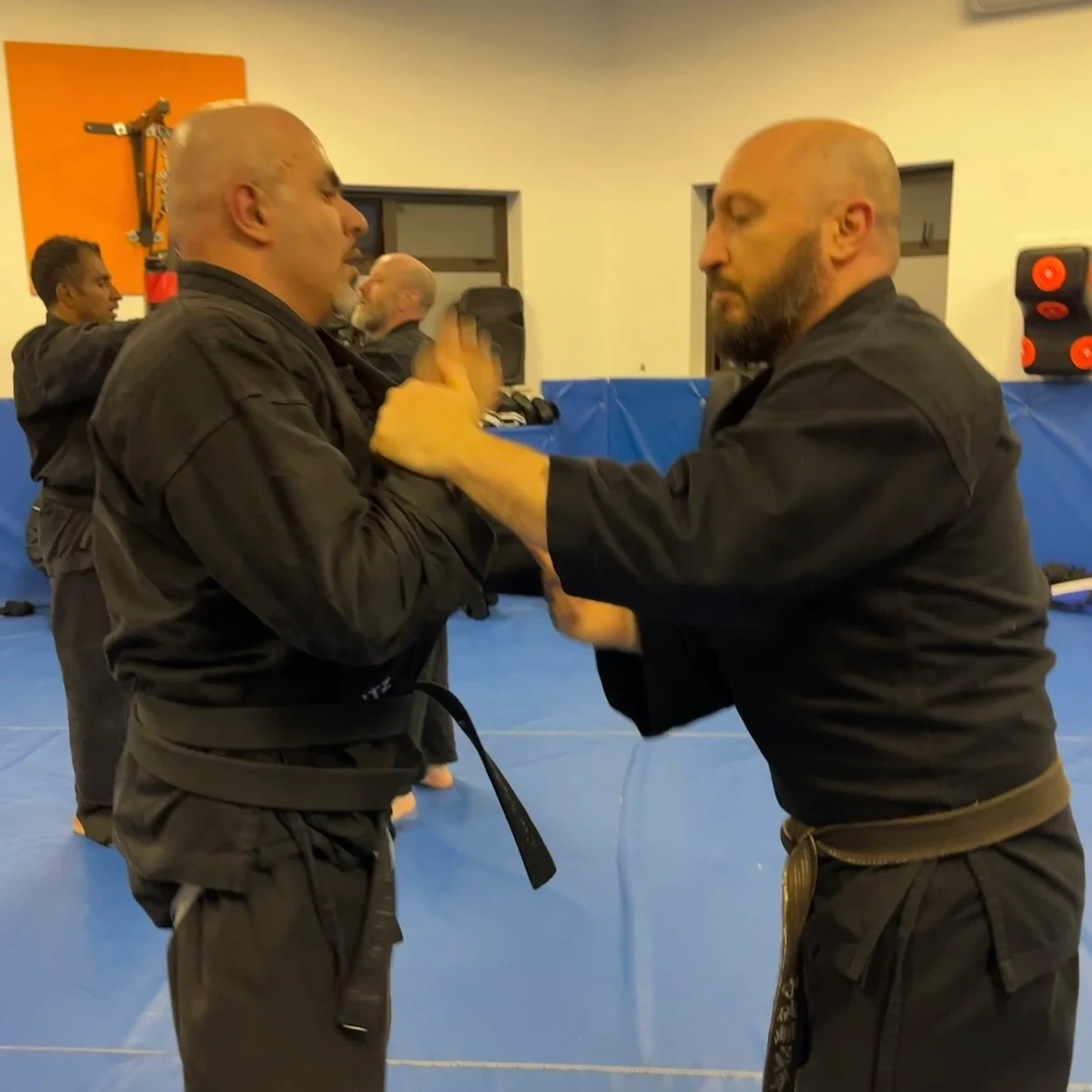 Majid Khalid of Shuhari Self Defence Slough learning vertical grappling from Olgun Tiltay in a martial arts class Majid Khalid of Shuhari Self Defence Slough learning vertical grappling from Olgun Tiltay in a martial arts class