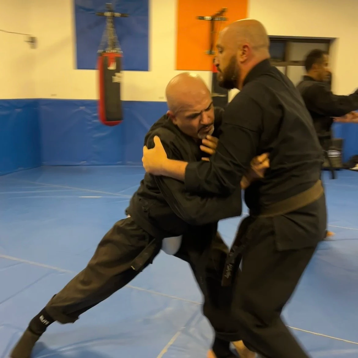 Majid Khalid of Shuhari Self Defence Slough learning vertical grappling from Olgun Tiltay in a martial arts session Majid Khalid of Shuhari Self Defence Slough learning vertical grappling from Olgun Tiltay in a martial arts session