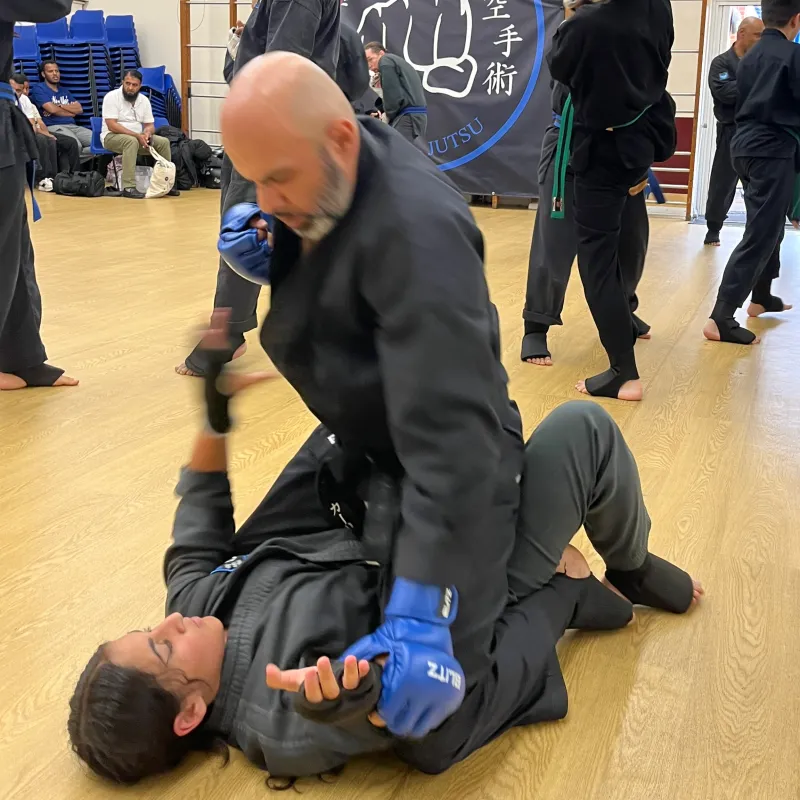 Majid Khalid of Shuhari Self Defence Slough assessing a student in a martial arts grading in Maidenhead