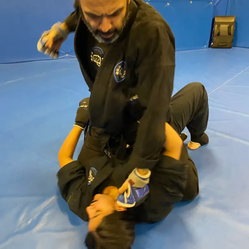 Majid Khalid of Shuhari Self Defence Slough assessing a student with ground and pound in an MMA class