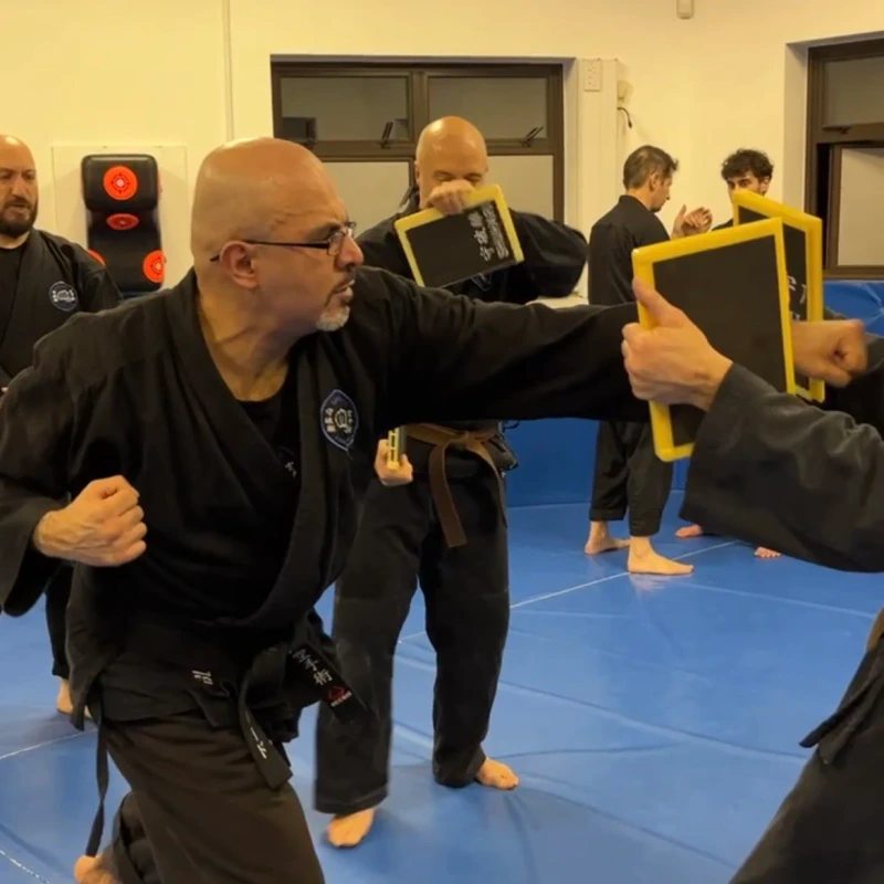 Majid Khalid of Shuhari Self Defence Slough practicing board breaking in a karate class