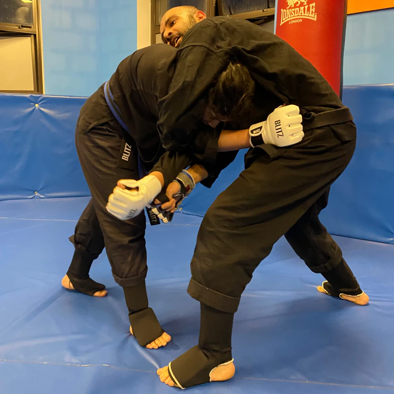 Majid Khalid of Shuhari Self Defence Slough sparring with a student in an MMA class
